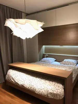 a bedroom with two beds and a chandelier at Design Apartment in Park in Sofia