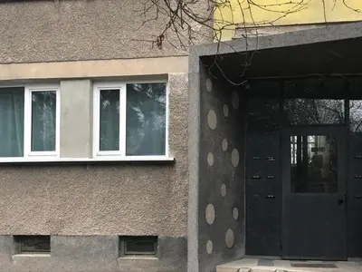 a building with a black door and a window at Design Apartment in Park in Sofia