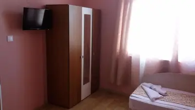a bedroom with a bed and a tv and a window at Guest Rooms Filipopol in Plovdiv