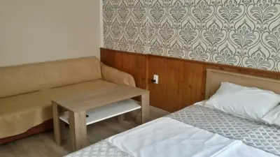 a room with a bed and a couch and a table at Guest Rooms Filipopol in Plovdiv