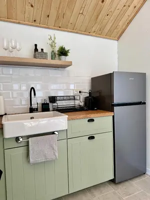 a kitchen with a sink and a refrigerator at High Five Villas in Pamporovo