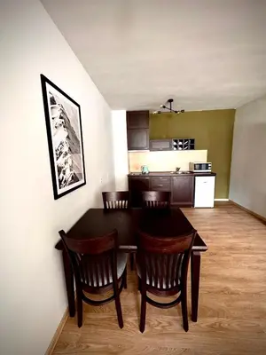 a kitchen and dining room with a table and chairs at Bansko Royal Towers Hotel in Bansko