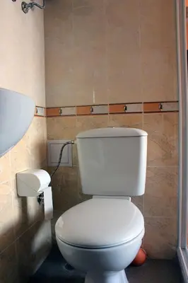 a bathroom with a white toilet and a sink at Osogovo Rooms in Sofia