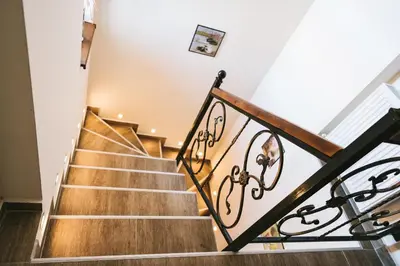 a staircase in a home with wooden floors at Villa Maria, Complex Aleksandria in Dobrinishte