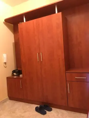a large wooden cabinet in a room at Apartment Elena in Sandanski