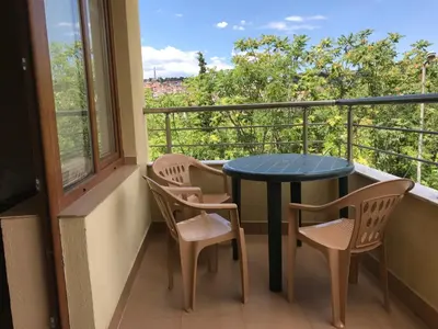 a balcony with a blue table and two chairs at Apartment Elena in Sandanski
