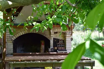 a brick fireplace with beer bottles in it at Villa Kabasanov in Smolyan