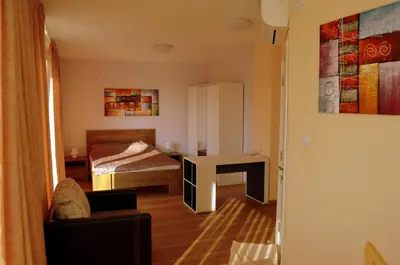 a small room with a bed and a desk at Апарт Център Apart Center in Plovdiv