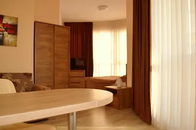 a living room with a table and a bedroom at Апарт Център Apart Center in Plovdiv
