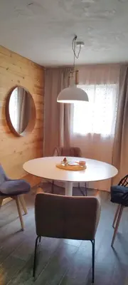 a dining room with a white table and a chair at Apartments 18 in Velingrad
