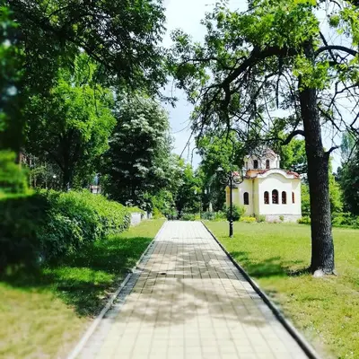 a walkway in front of a building in a park at Apartments 18 in Velingrad