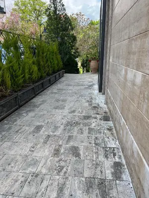 a stone walkway next to a building with plants at Park Hotel Sandanski in Sandanski