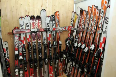 a bunch of skis are lined up against a wall at Villa Ibar in Borovets