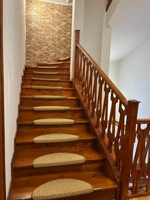 a staircase with wooden steps with a brick wall at Villa Ibar in Borovets
