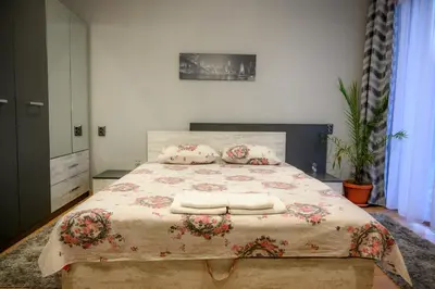 a bedroom with a large bed with pillows on it at Guest House Angelkovi in Sapareva Banya
