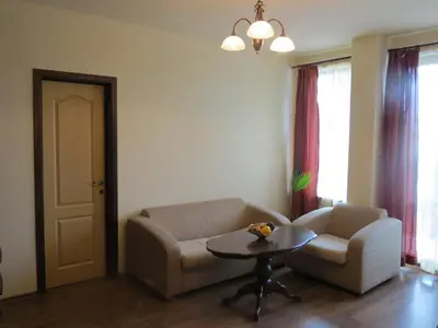 a living room with a couch and a table at Apartments & Studios Mountain Romance in Bansko