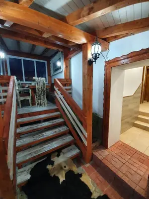 a room with wooden stairs in a house at Kashtata s Paraklisa in Borowo