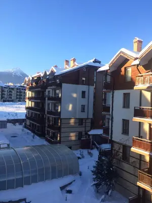 a view of a building in the snow at Apartments Four Leaf Clover Bansko to rent in Bansko