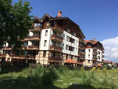 a large apartment building with many balconies on it at Apartments Four Leaf Clover Bansko to rent in Bansko