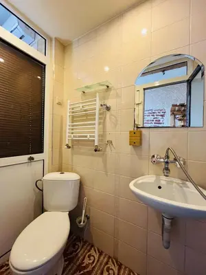 a bathroom with a toilet and a sink at Rooms43 in Sofia