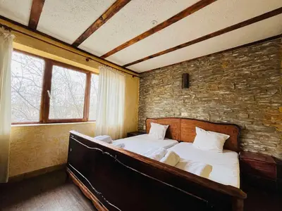 a bedroom with a large bed in a brick wall at Rooms43 in Sofia
