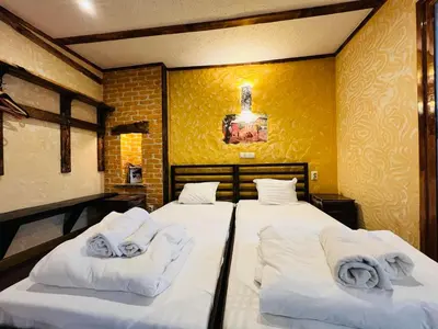 two beds in a room with towels on them at Rooms43 in Sofia