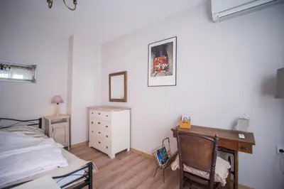 a bedroom with a desk and a bed and a dresser at The Bookies Apartments in Sofia