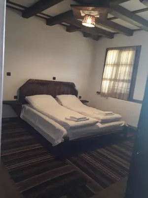 a bedroom with a large bed in a room at Kyshta za Gosti Gospodevi in Gorno Dryanovo