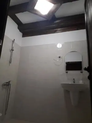 a bathroom with a sink and a mirror at Kyshta za Gosti Gospodevi in Gorno Dryanovo