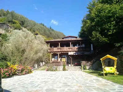 a house with a yellow playground in front of it at Kyshta za Gosti Gospodevi in Gorno Dryanovo
