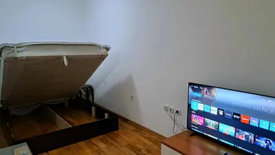 a flat screen tv sitting on a table next to a wall at Mountain View A23 in Bansko