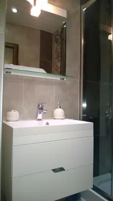 a bathroom with a white sink and a mirror at Apartment Ira in Velingrad
