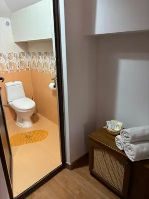 a bathroom with a toilet and a glass door at Yovkovata Kyshta in Chiflik