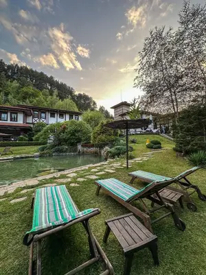 two chairs and a picnic table next to a river at SPA Hotel Ismena in Devin