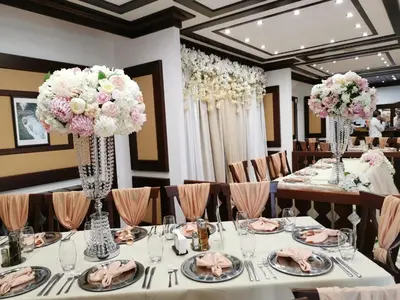 a table set up for a wedding with vases of flowers at SPA Hotel Ismena in Devin