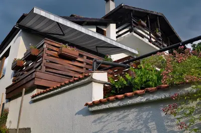 a building with a balcony with plants on it at Sapareva Kashta in Sapareva Banya