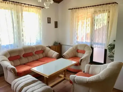 a living room with two couches and a table at Daf Trans Hotel in Peshtera