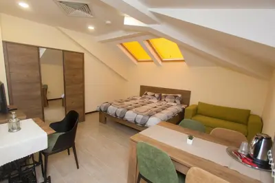 a bedroom with a bed and a table and chairs at Sofia Family House - Free Parking in Sofia