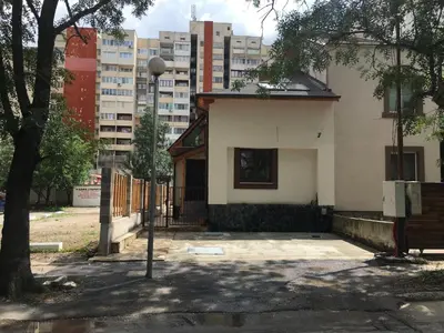 a white house with a tree and some buildings at Sofia Family House - Free Parking in Sofia
