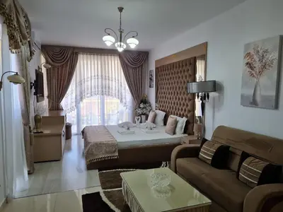 a living room with a bed and a couch at Hotel Dalia - Bankya in Bankya