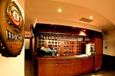 a bar in a restaurant with glasses on the wall at Family Hotel EDI in Sofia