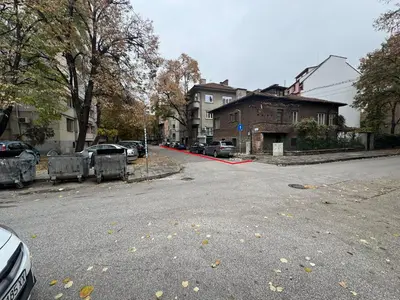 an empty street with cars parked on the road at Apartment Trimontium in Plovdiv