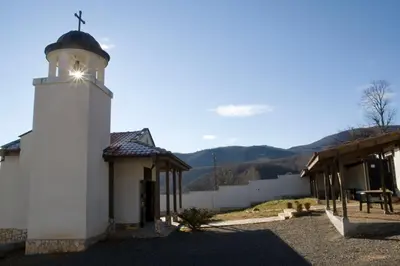 a small white church with a cross on top of it at Вила Бойковец in Boykovets