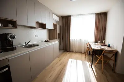 a kitchen with a sink and a table and a window at Court Inn in Panagyurishte