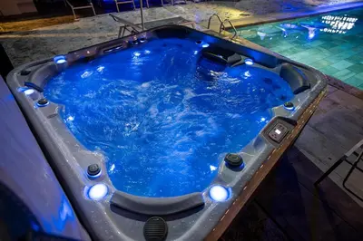 a jacuzzi tub with blue water in it at Комплекс язовир Валтата Komplex yazovir VALTATA in Samuilovo