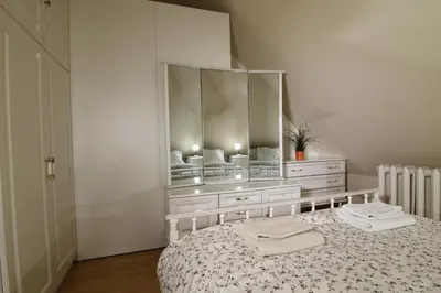 a bedroom with a bed with a large mirror at Guest Rooms Stay Nexus in Sofia