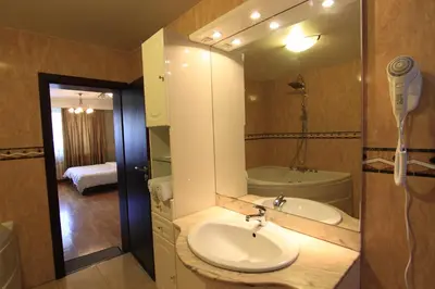 a bathroom with a sink and a shower and a mirror at Guest Rooms Stay Nexus in Sofia