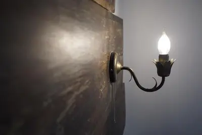 a light attached to a wall next to a wall at Pisanata House in Dedovo
