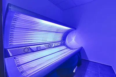 a bed in a room with a purple light at Belvedere Holiday Club in Bansko