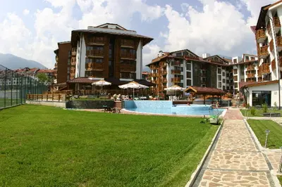 a resort with a swimming pool and some buildings at Belvedere Holiday Club in Bansko